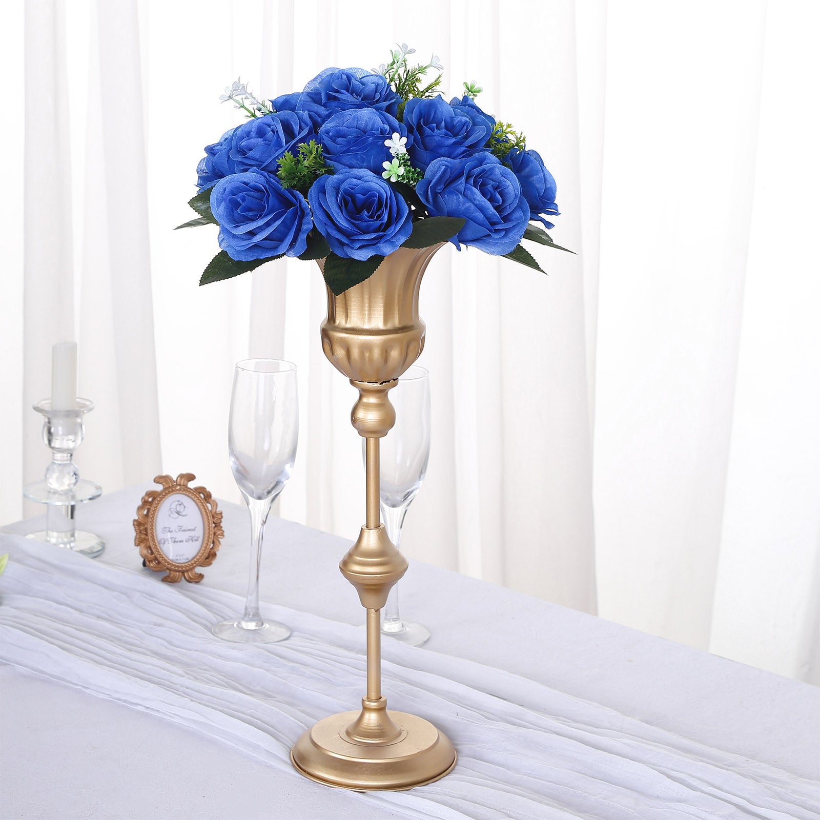 Royal blue silk rose flower ball centerpiece arrangement in a gold vase.