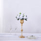 White silk rose flower ball centerpiece arrangement in a gold vase.