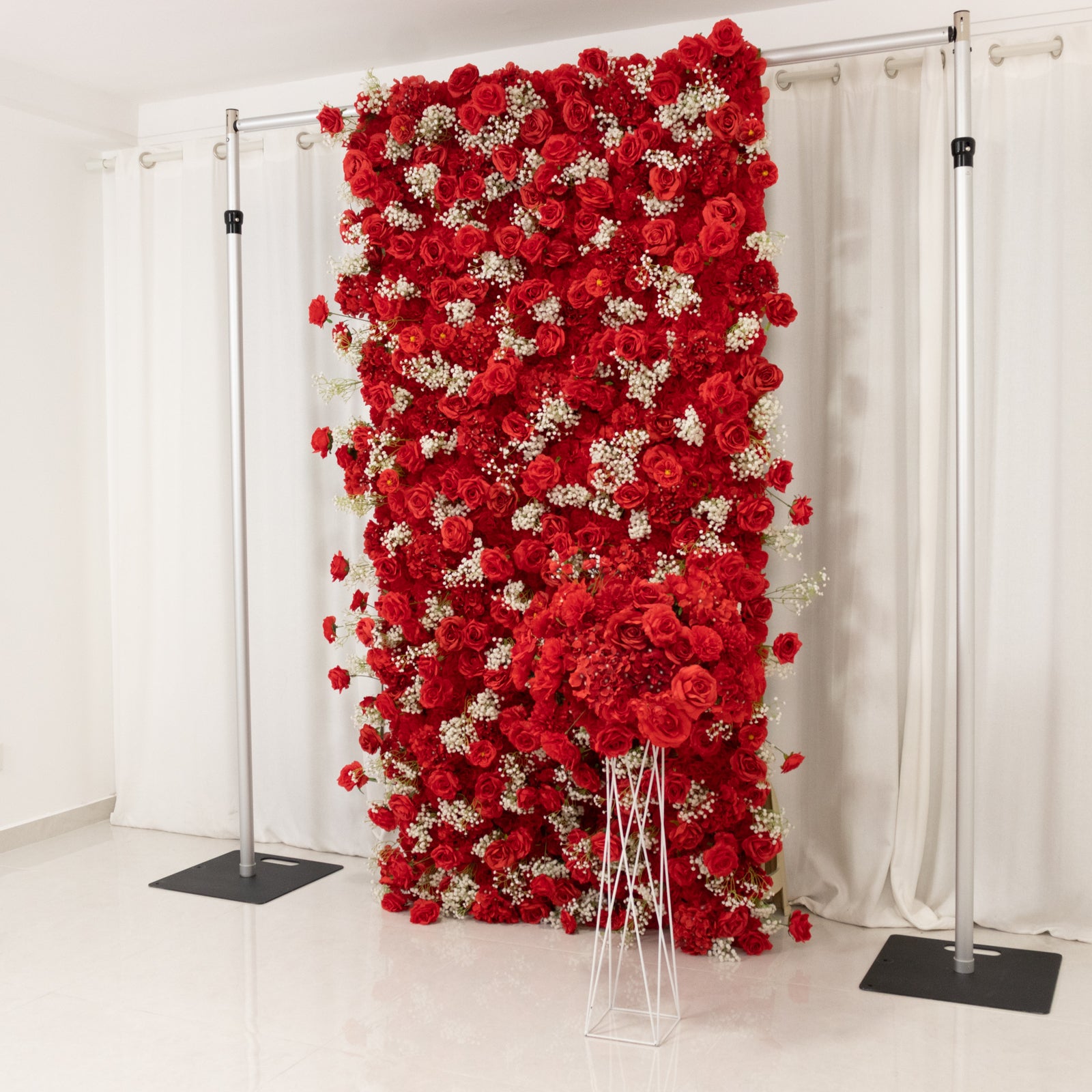 Red silk roses and baby's breath wall panel backdrop.