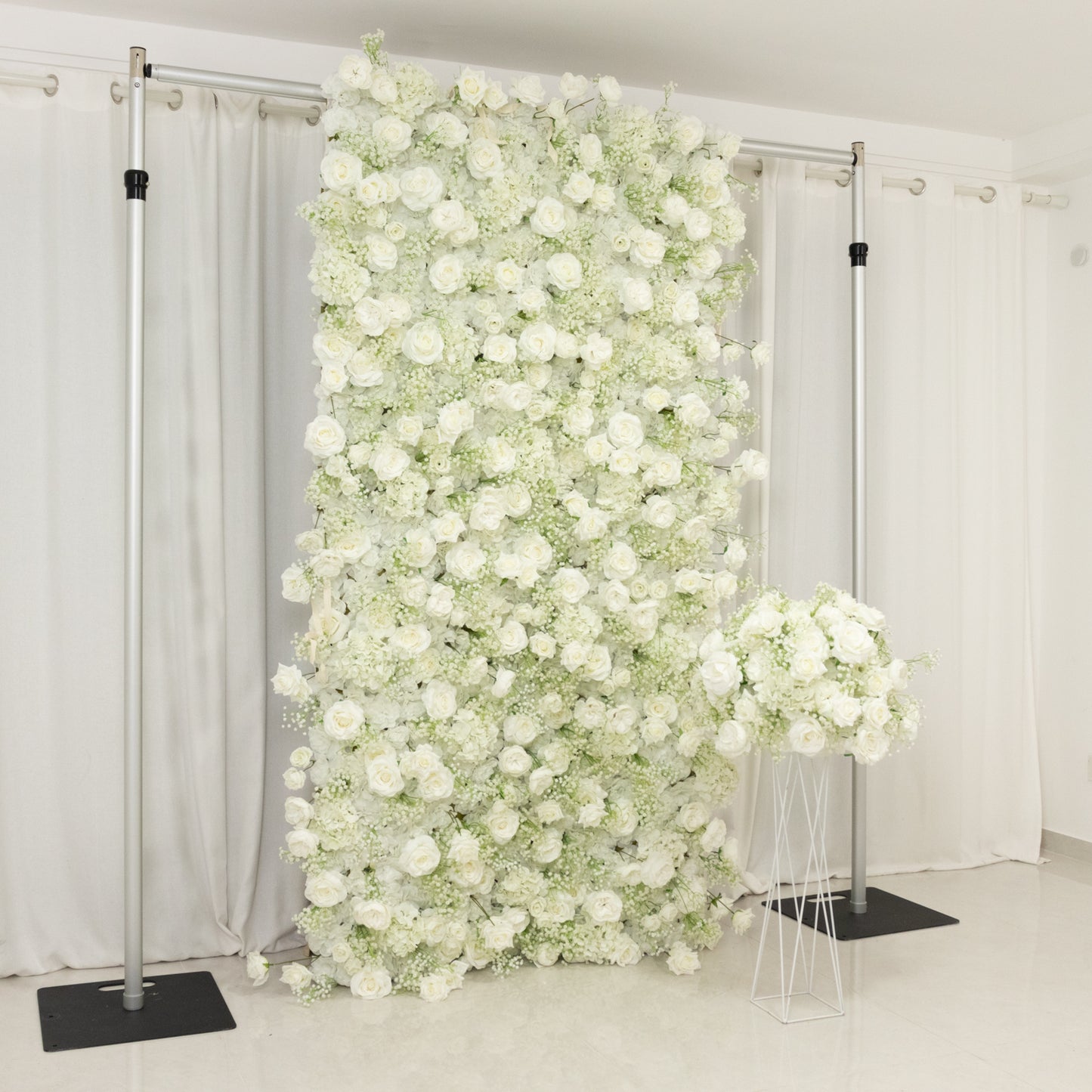 White silk rose wall backdrop with baby's breath.