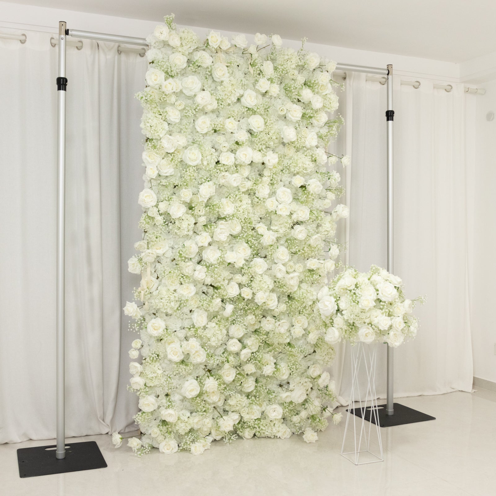 White silk rose wall backdrop with baby's breath.