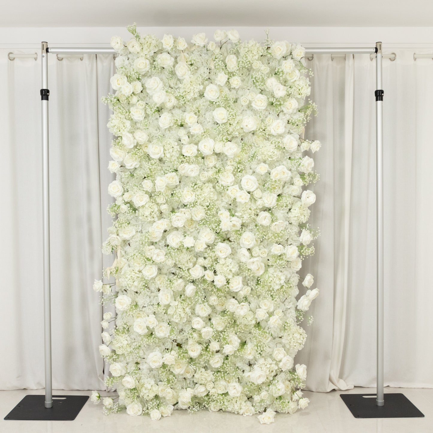 White silk roses and baby's breath artificial flower wall backdrop.