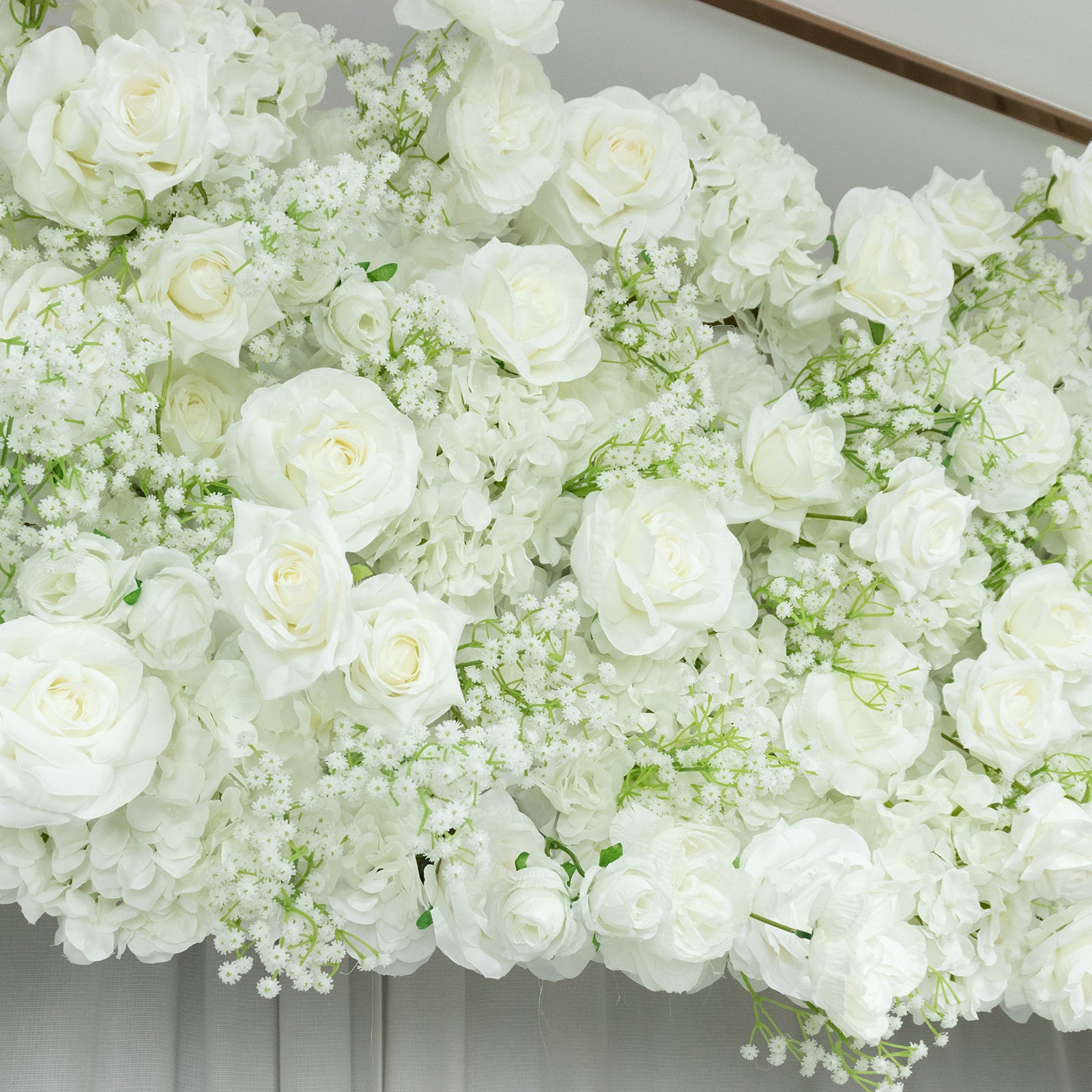 White silk roses and baby's breath artificial flower backdrop for wedding decor.