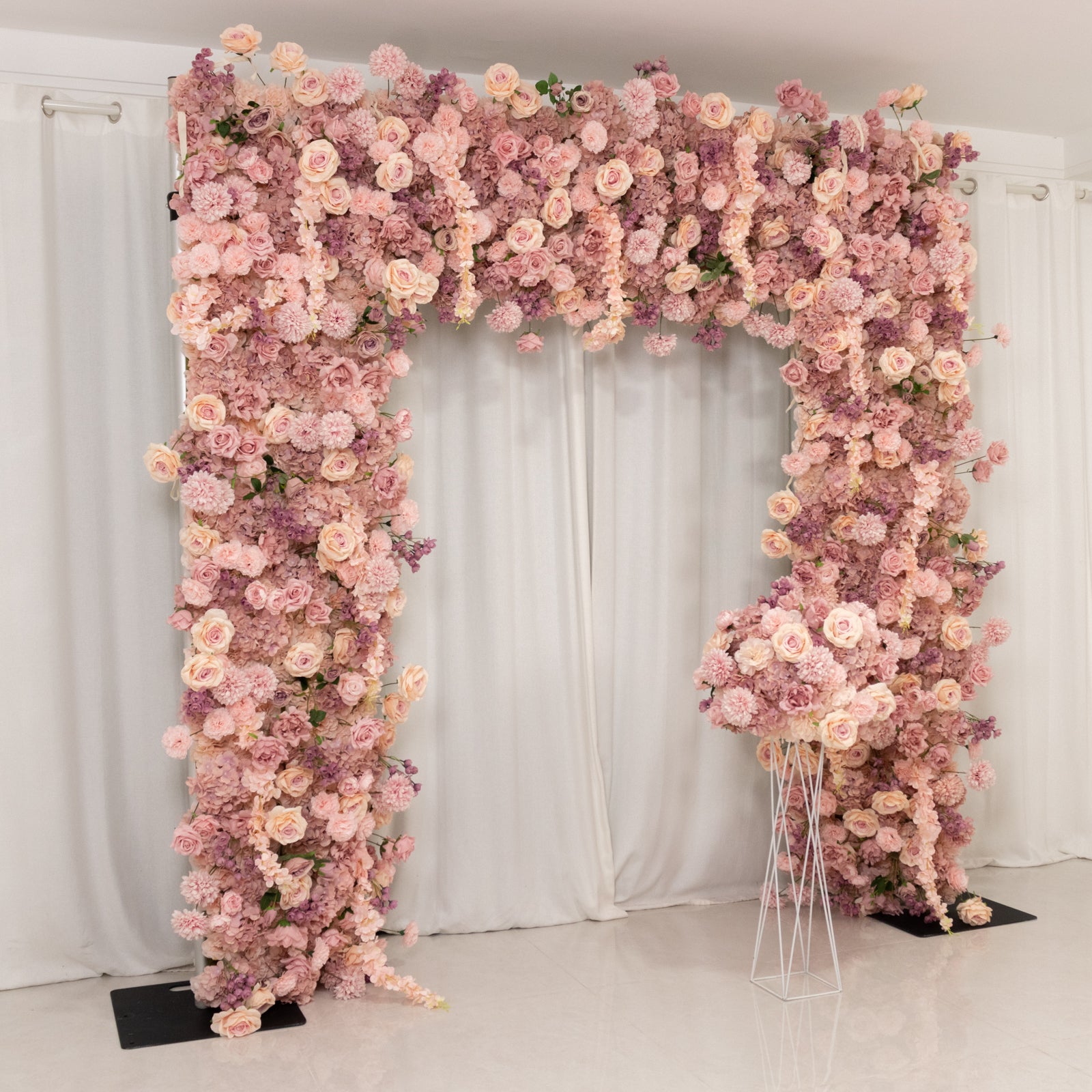 Dusty rose flower backdrop with artificial silk roses and hydrangeas.