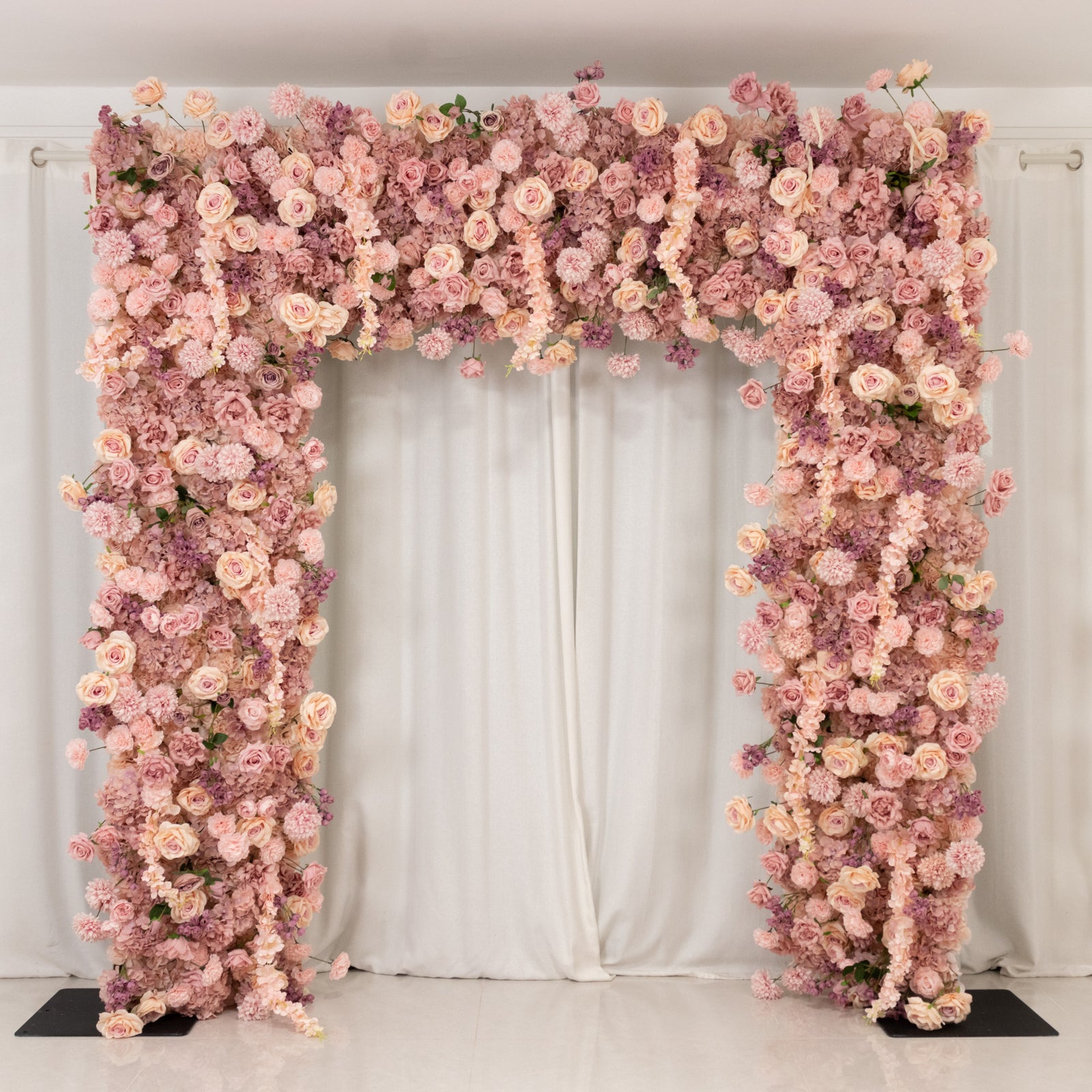 Dusty rose floral backdrop for weddings with artificial silk flowers.