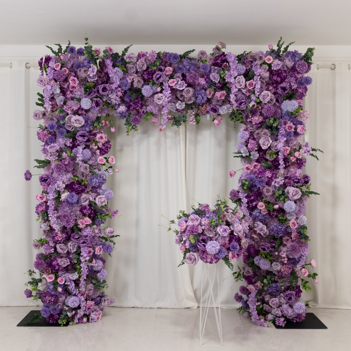 Lavender lilac flower backdrop with artificial silk roses and hydrangeas.