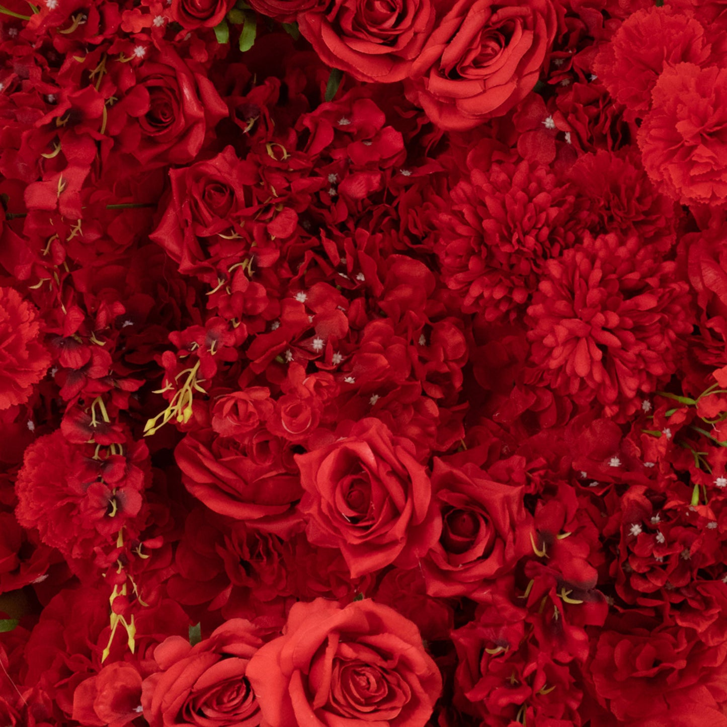 Red floral backdrop with artificial silk roses and hydrangeas for weddings.