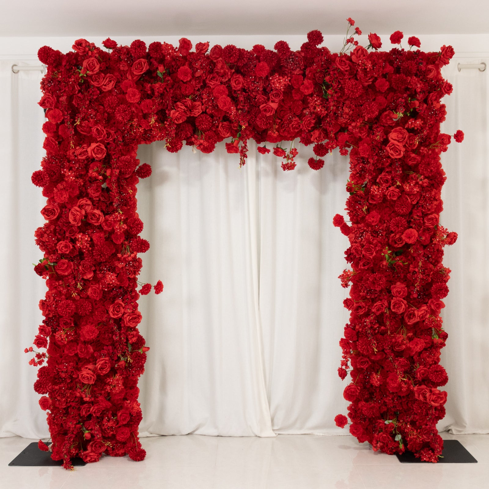 Red floral backdrop for arch stand with artificial silk roses and flowers.