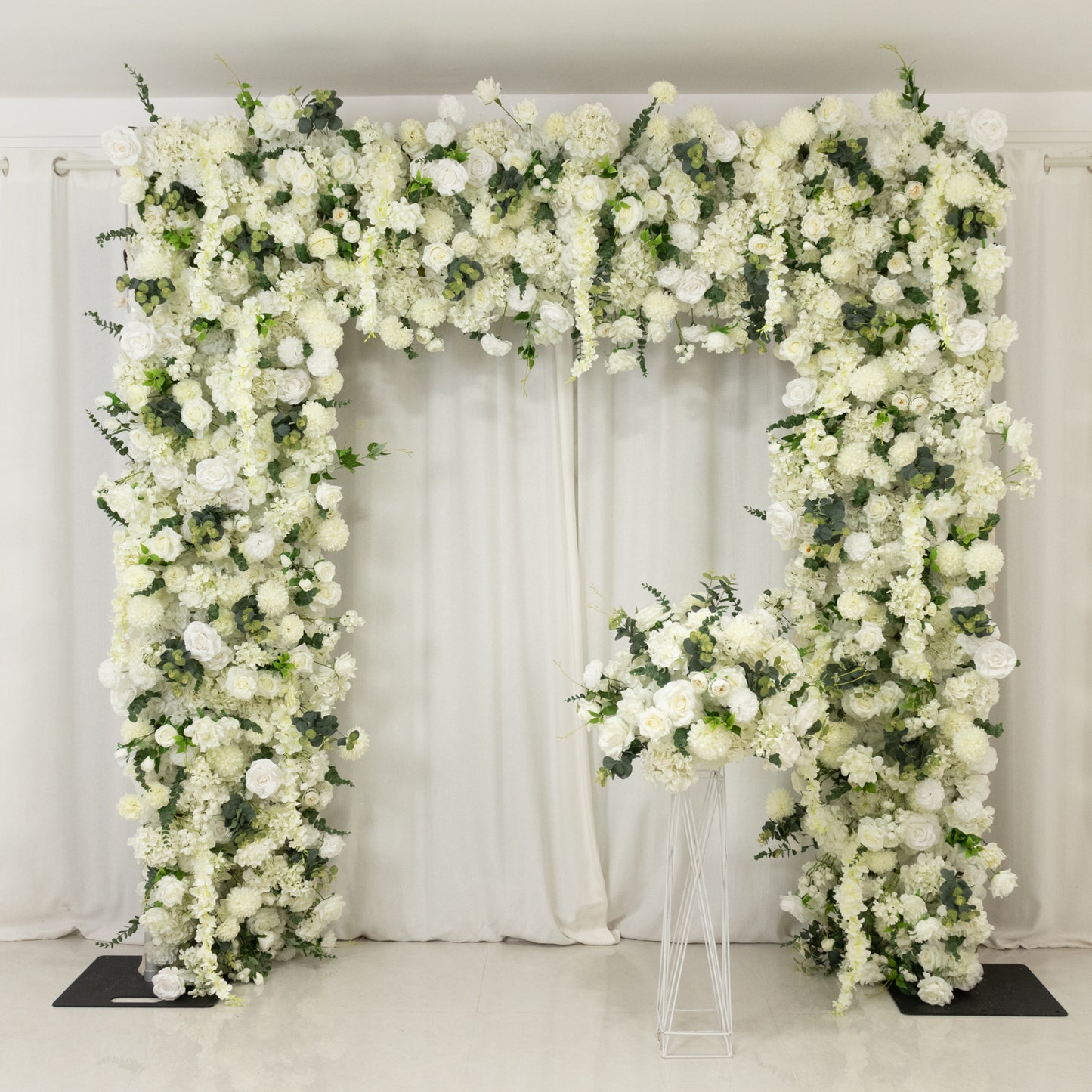 White floral backdrop with artificial silk roses and hydrangeas for weddings.