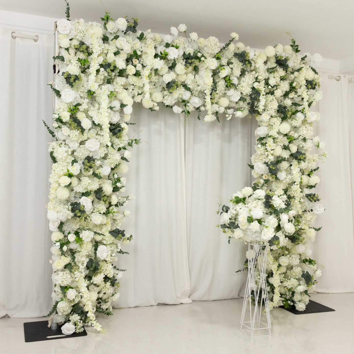 White floral backdrop with artificial silk roses, hydrangeas, and chrysanthemums.
