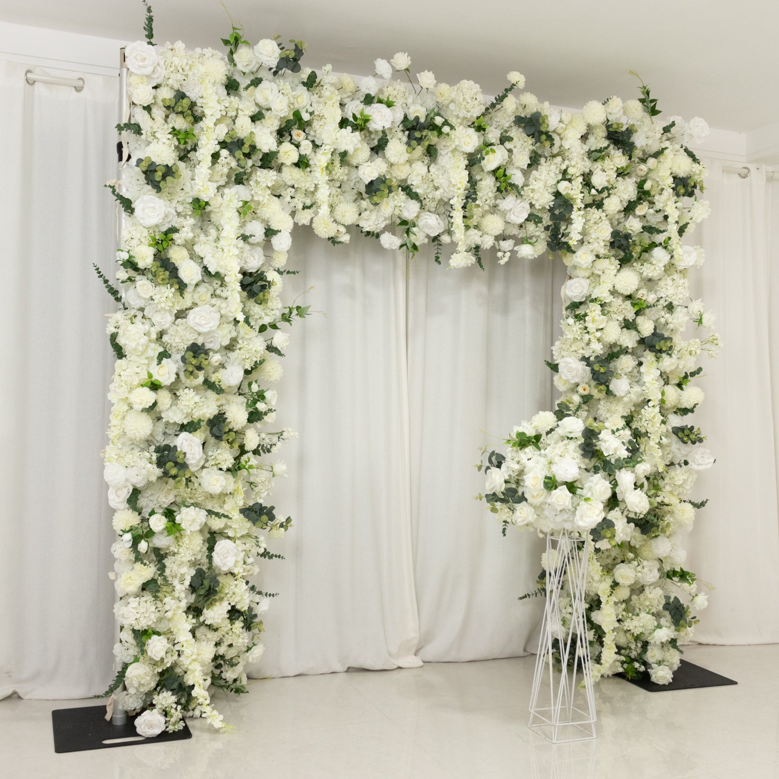 White floral backdrop with artificial silk roses, hydrangeas, and chrysanthemums.