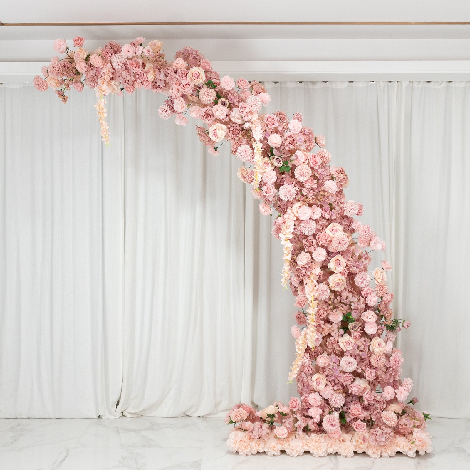Dusty rose floral backdrop for wedding arch with roses and hydrangeas.