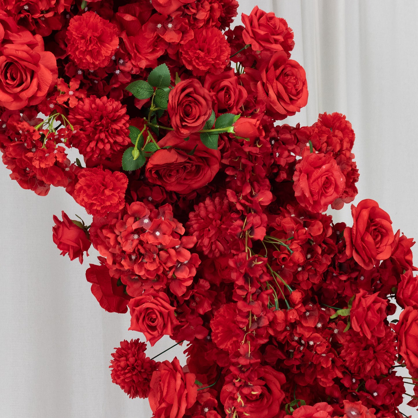 Red floral backdrop featuring roses, hydrangeas, and chrysanthemums for wedding decor.