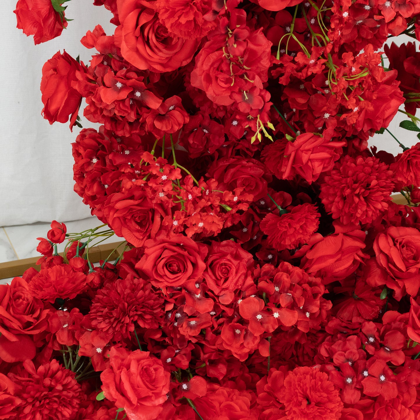 Red floral backdrop featuring roses, hydrangeas, and chrysanthemums.