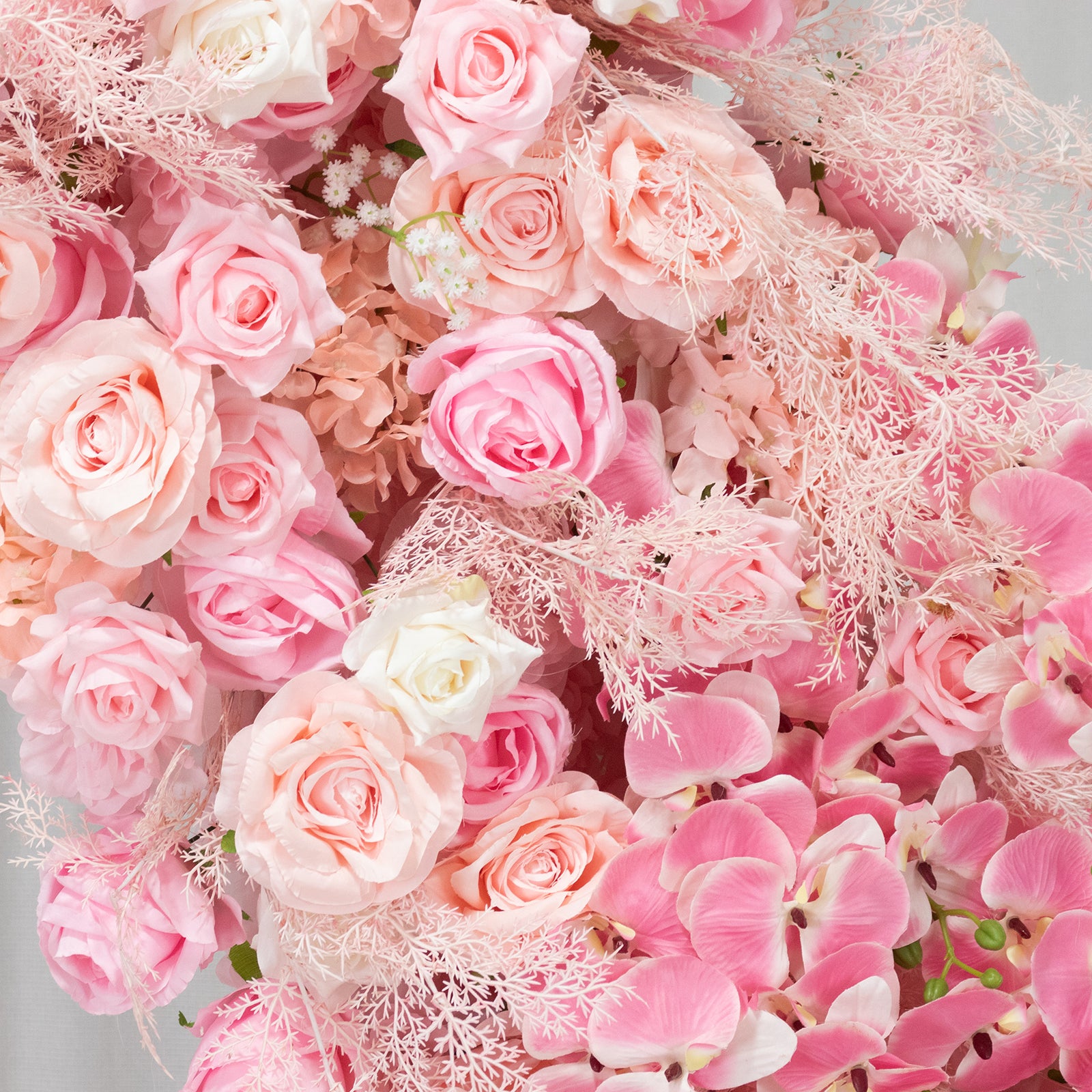 White and pink floral backdrop with roses and hydrangeas for wedding decor.