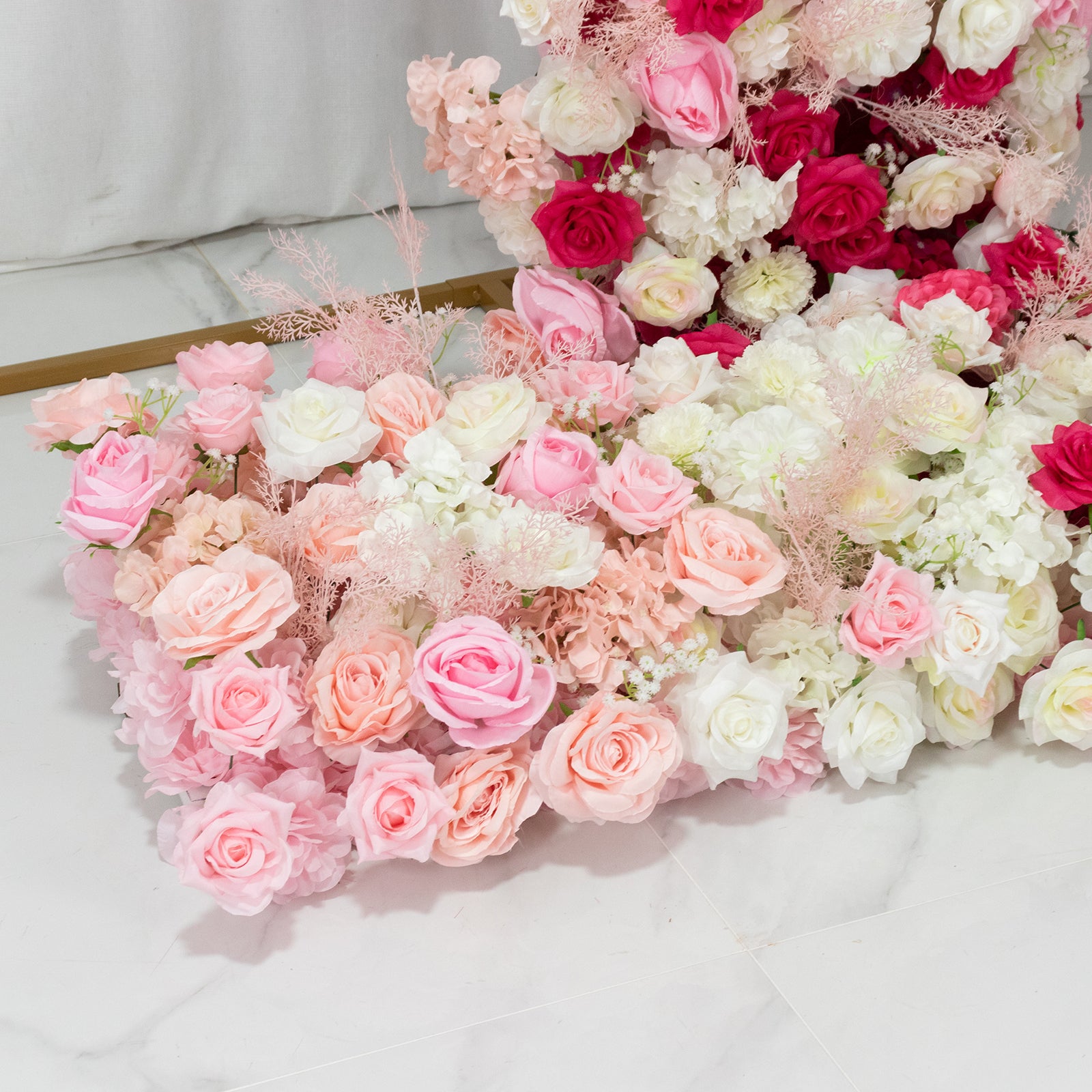 White and pink floral backdrop with roses and hydrangeas for wedding arch.