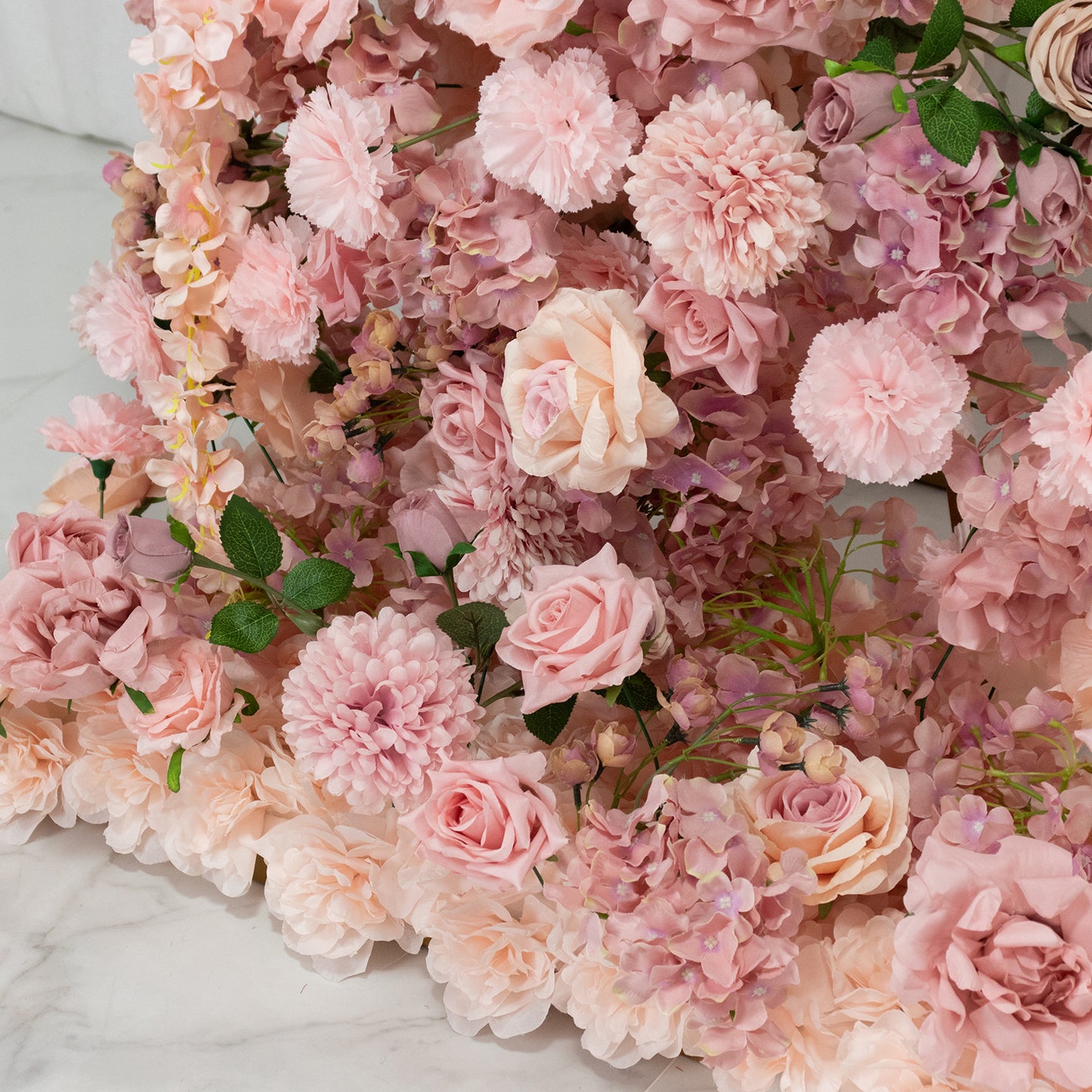 Dusty rose floral backdrop for a wedding arch with roses and hydrangeas.
