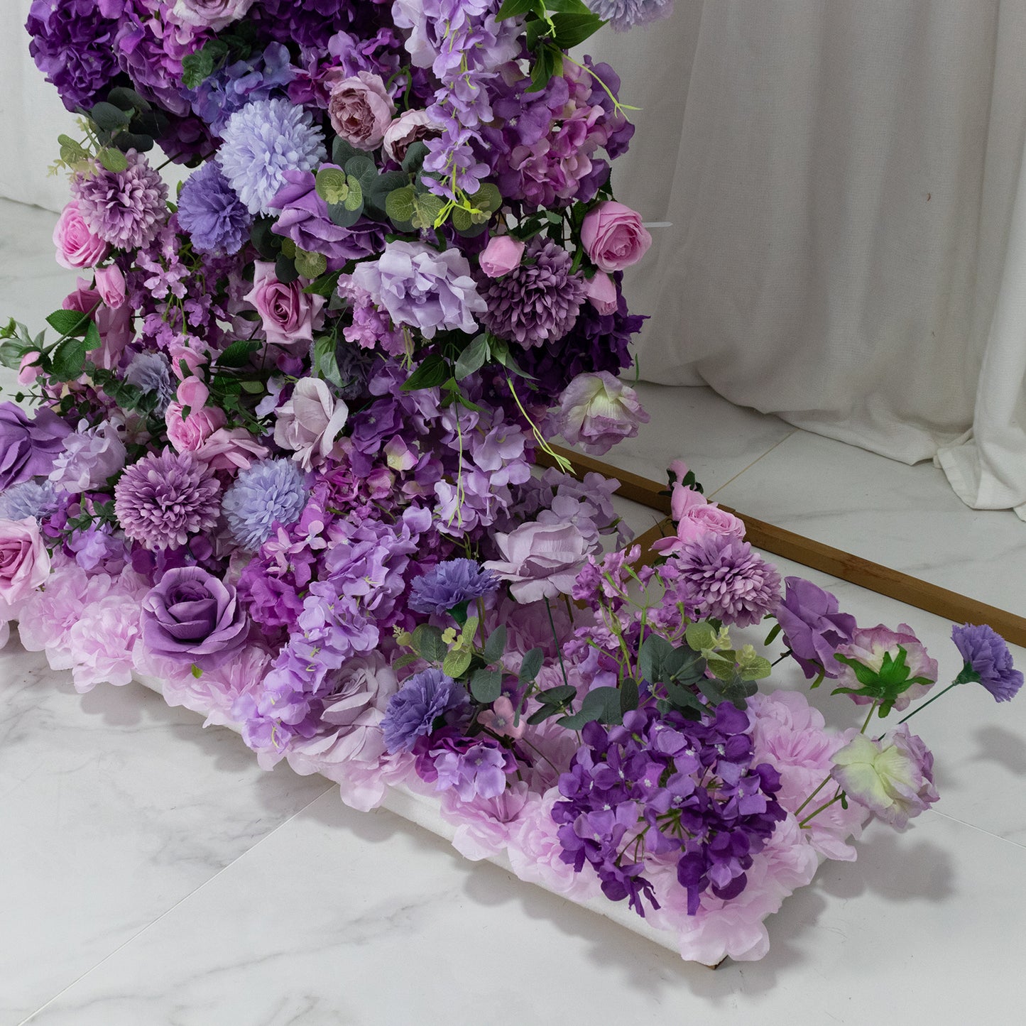 Lavender floral backdrop with roses, hydrangeas, and chrysanthemums for wedding arch.