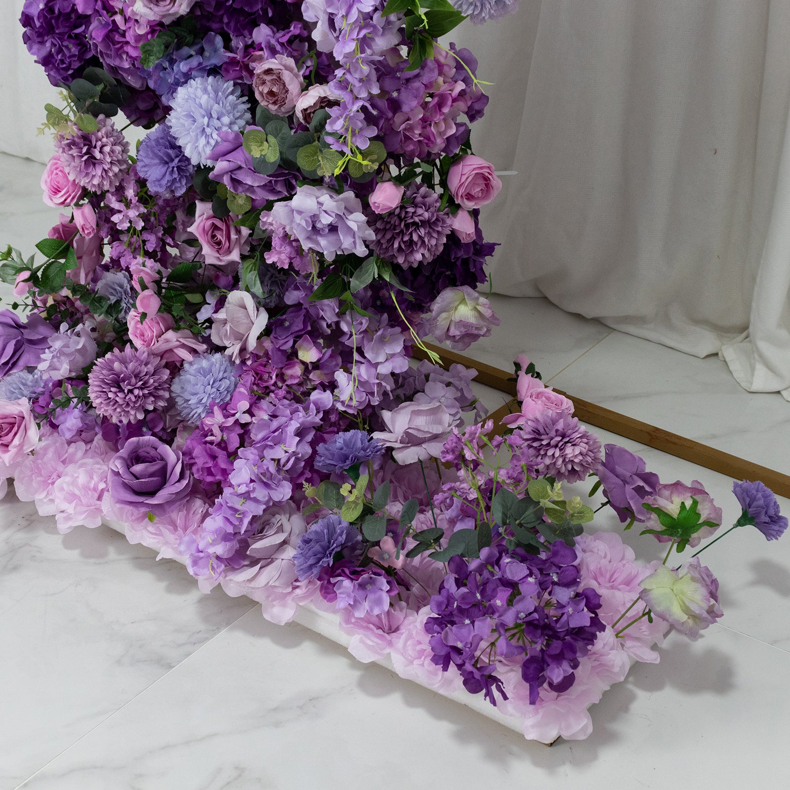 Lavender floral backdrop with roses, hydrangeas, and chrysanthemums for wedding arch.