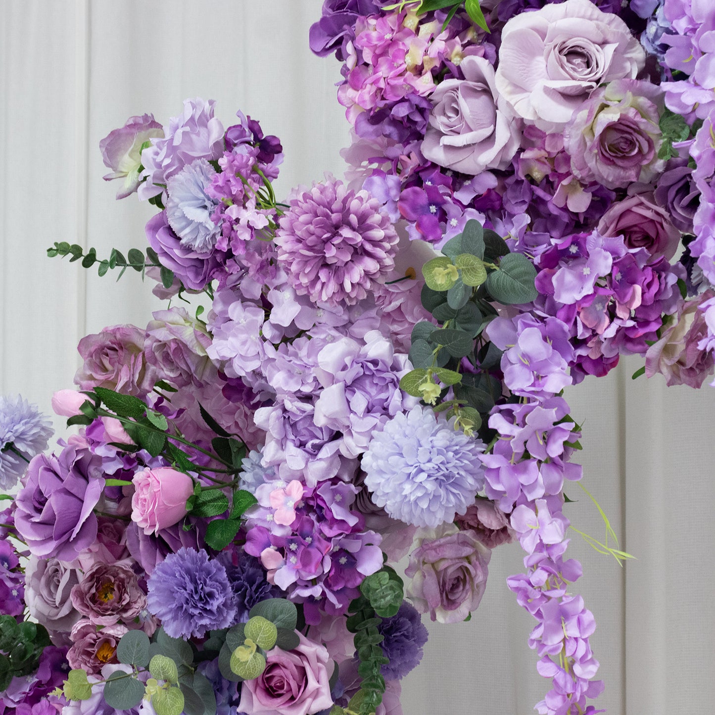 Lavender floral backdrop with roses, hydrangeas, and chrysanthemums.