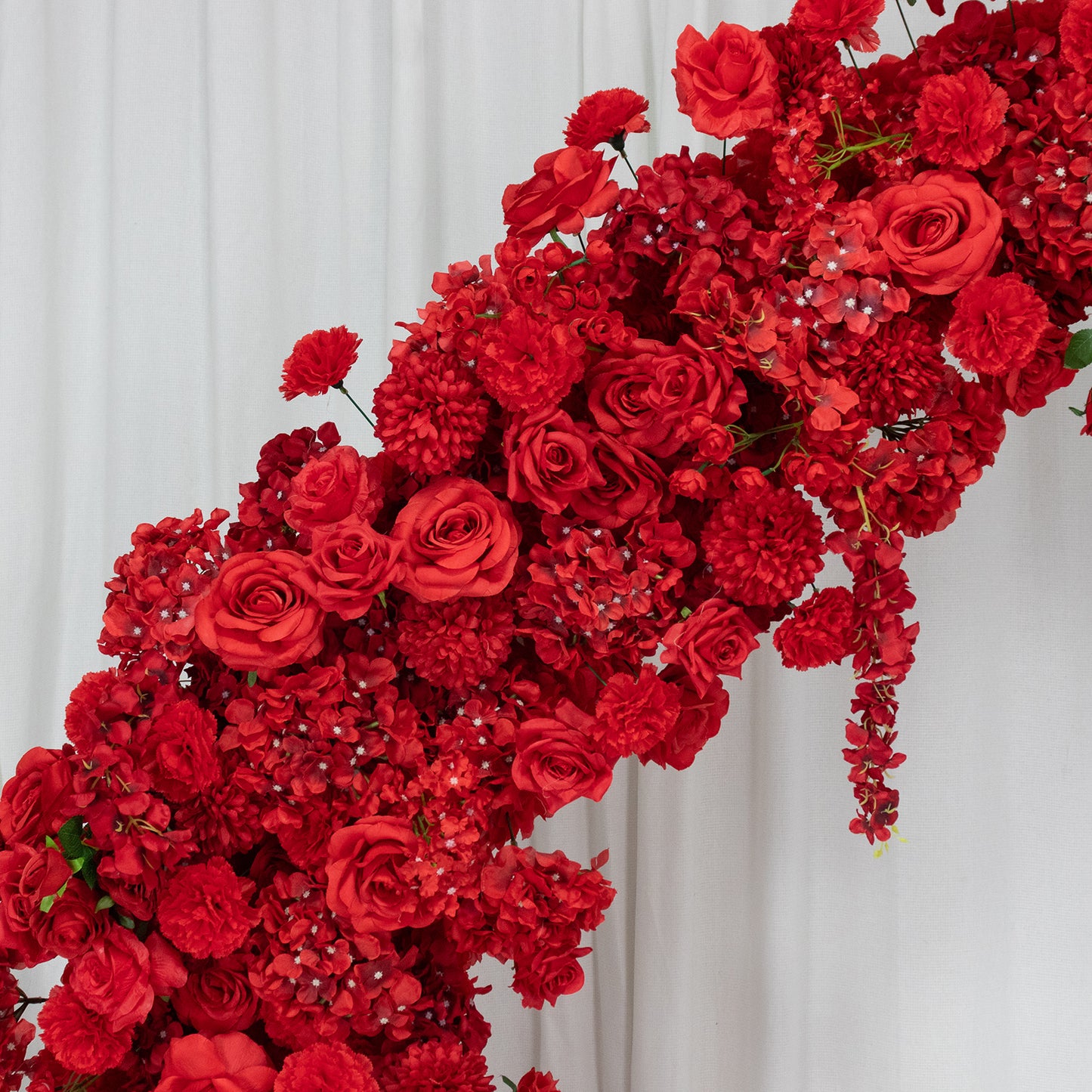 Red floral backdrop for a wedding arch featuring roses, hydrangeas, and chrysanthemums.