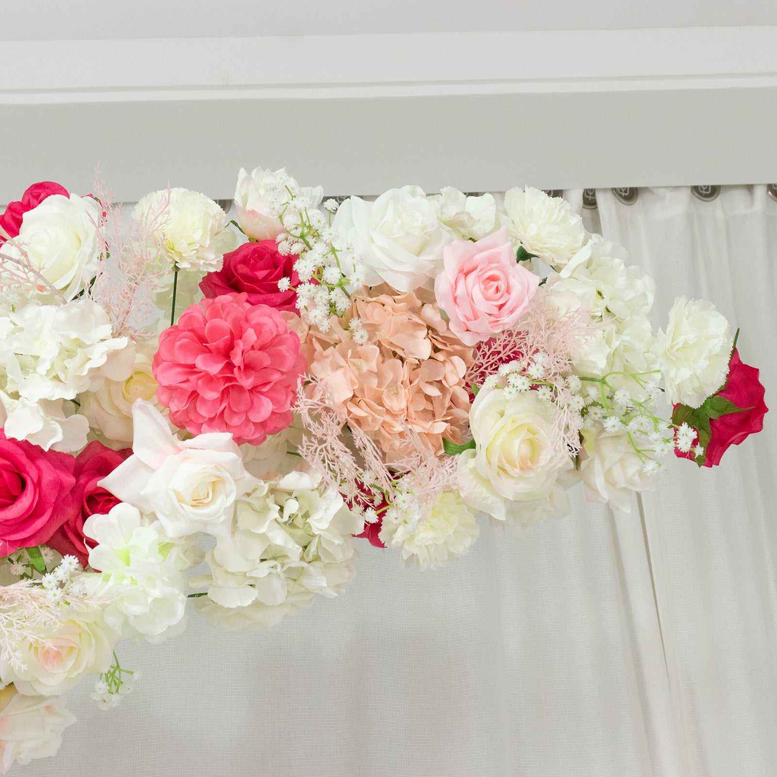 White and pink floral backdrop for wedding arch with roses and hydrangeas.