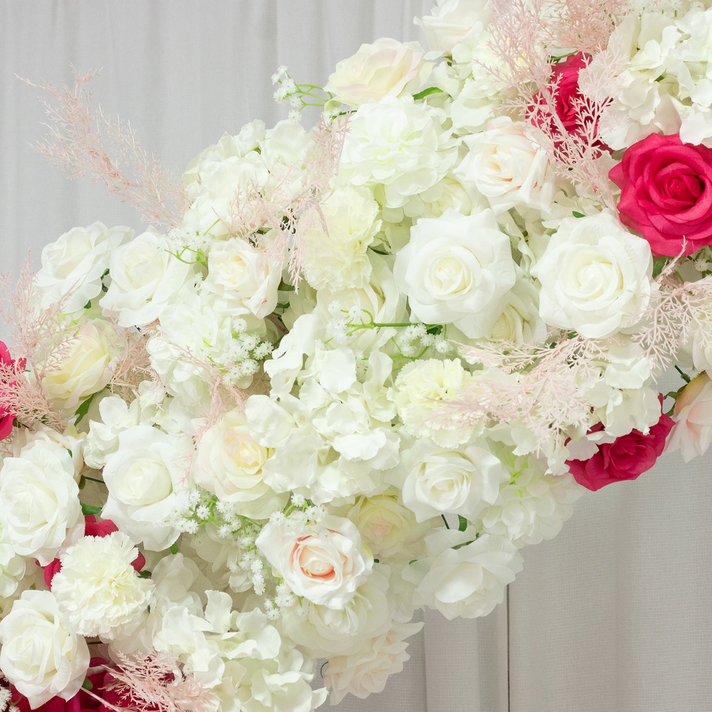 White and pink floral backdrop for wedding arch with roses and hydrangeas.