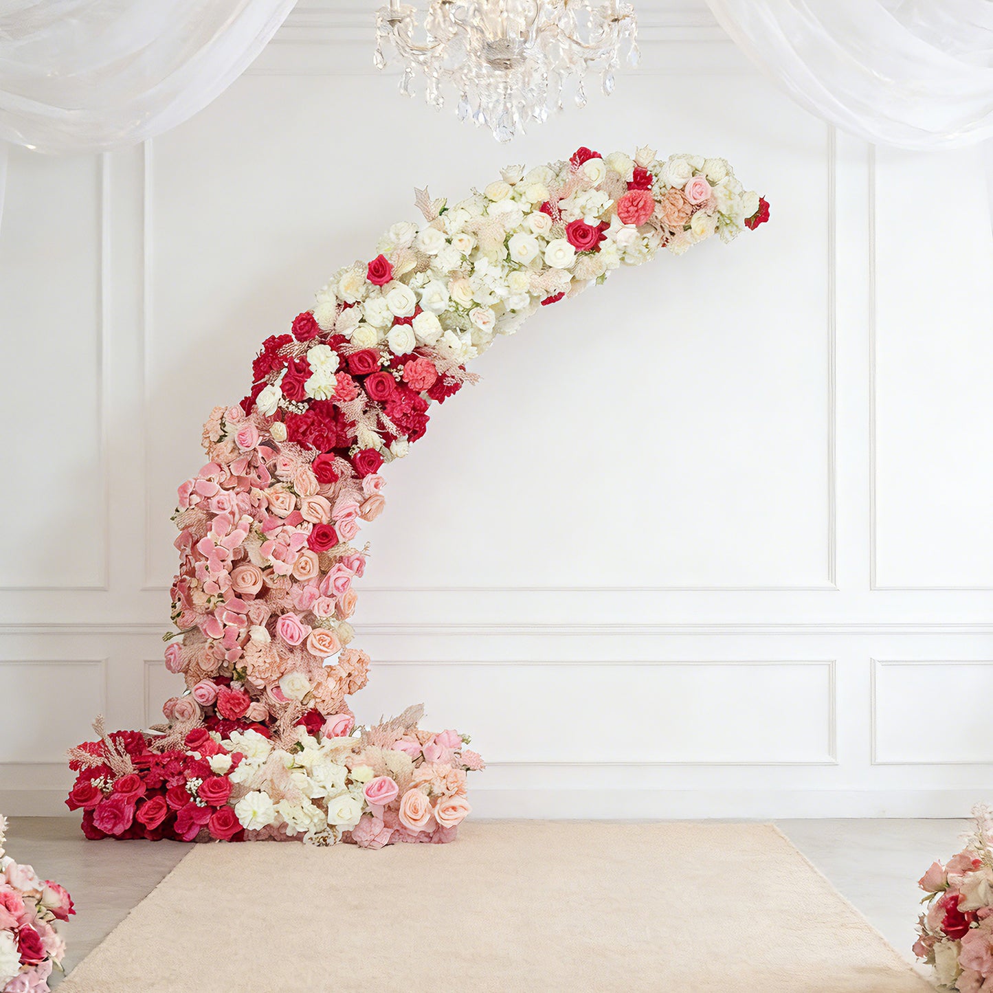 White and pink floral backdrop for a wedding arch with roses and hydrangeas.