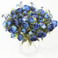 Navy blue artificial ranunculus floral arrangement in a clear vase.