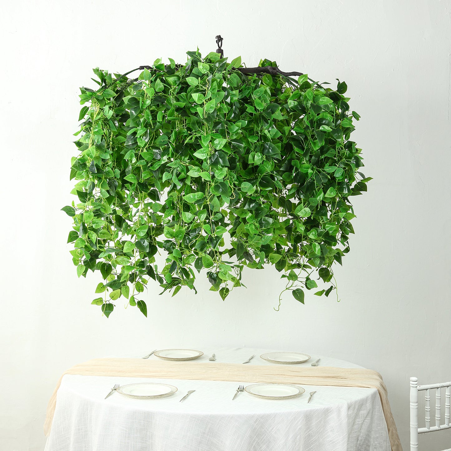 Green artificial eucalyptus leaf vines chandelier with draping ivy leaves.