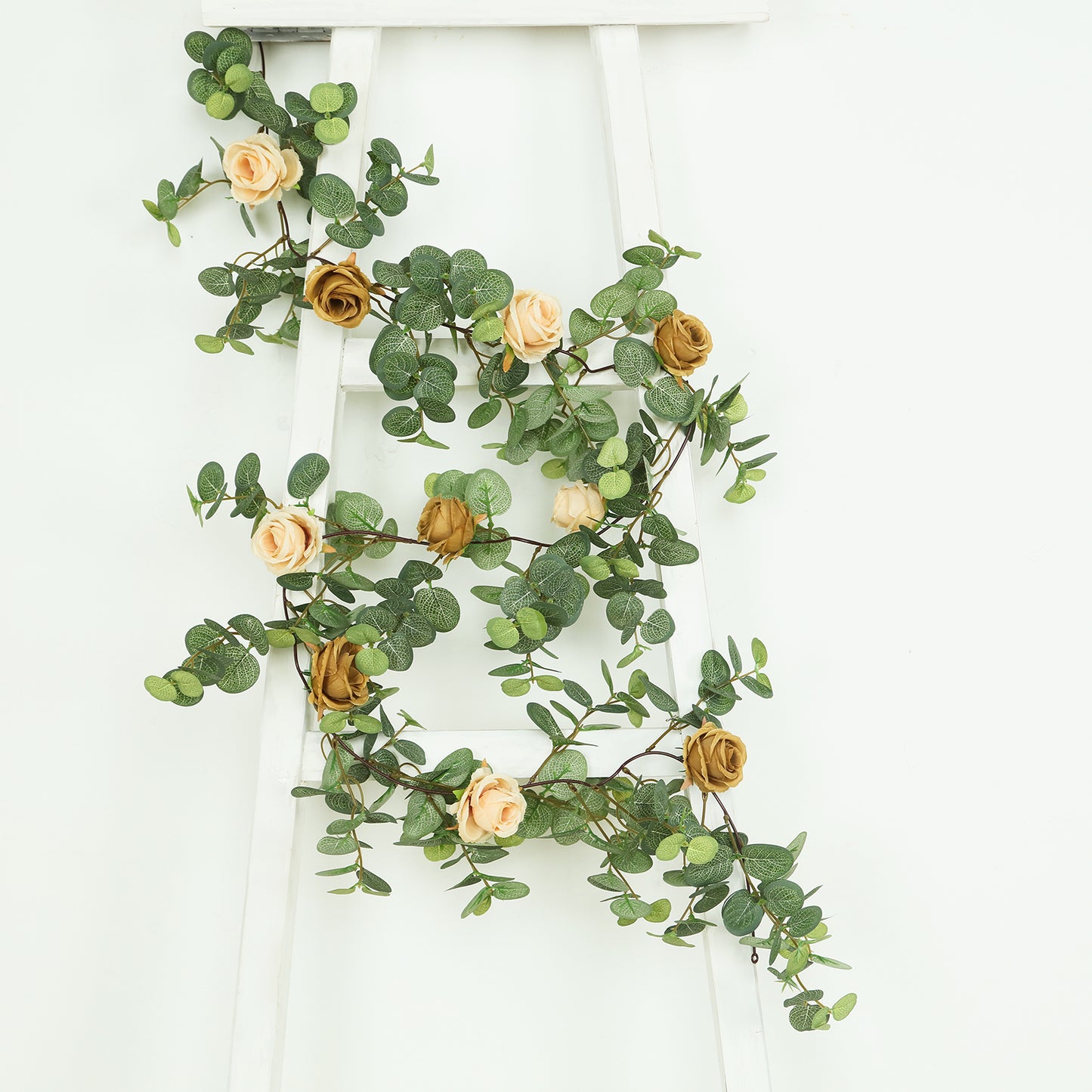 Cream and gold artificial eucalyptus garland with roses.
