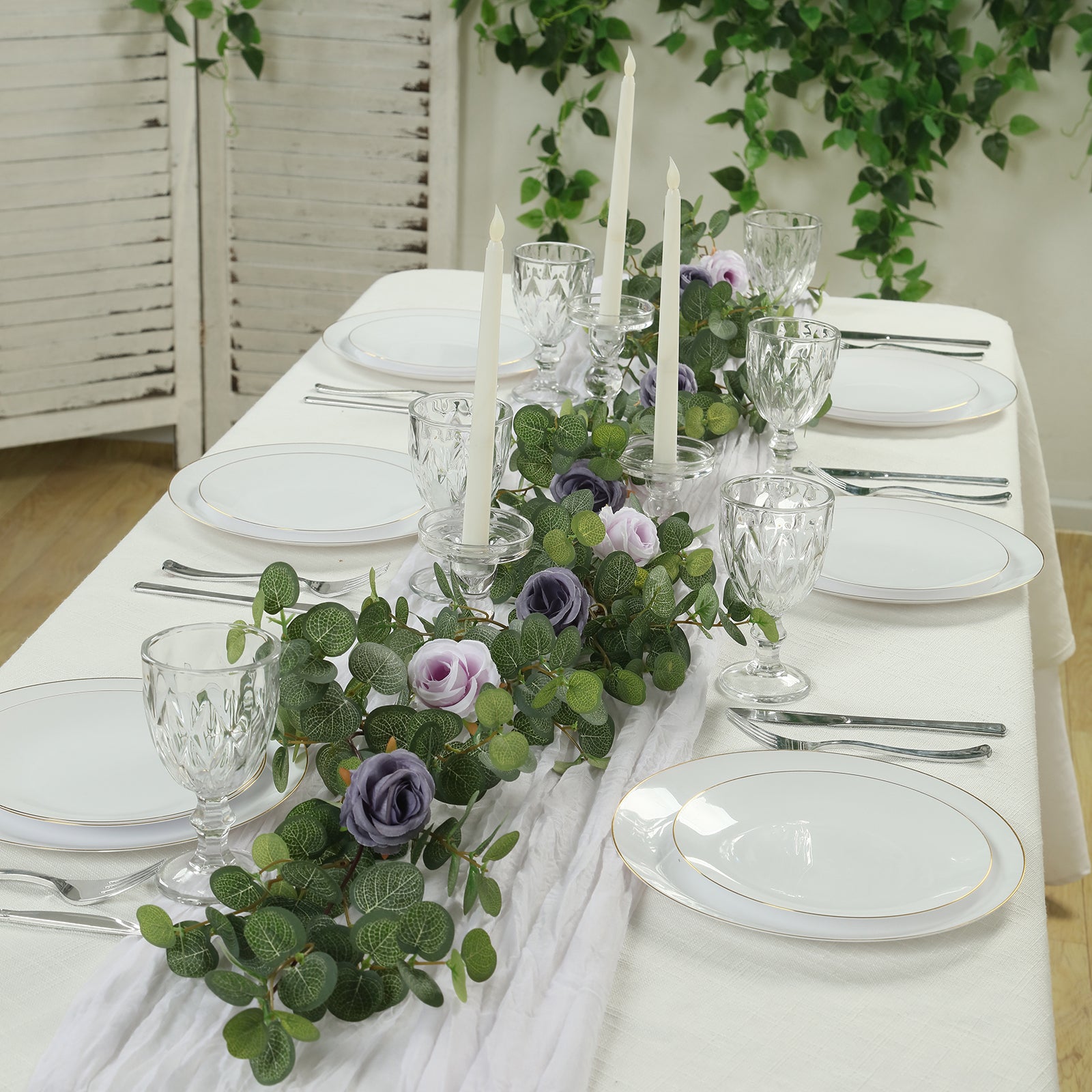 6ft artificial eucalyptus garland with lavender silk roses on a dining table.