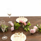 Blush dusty rose artificial silk flower garland with mini rose vines on a table.