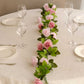 Blush dusty rose artificial silk flower garland on a table setting.