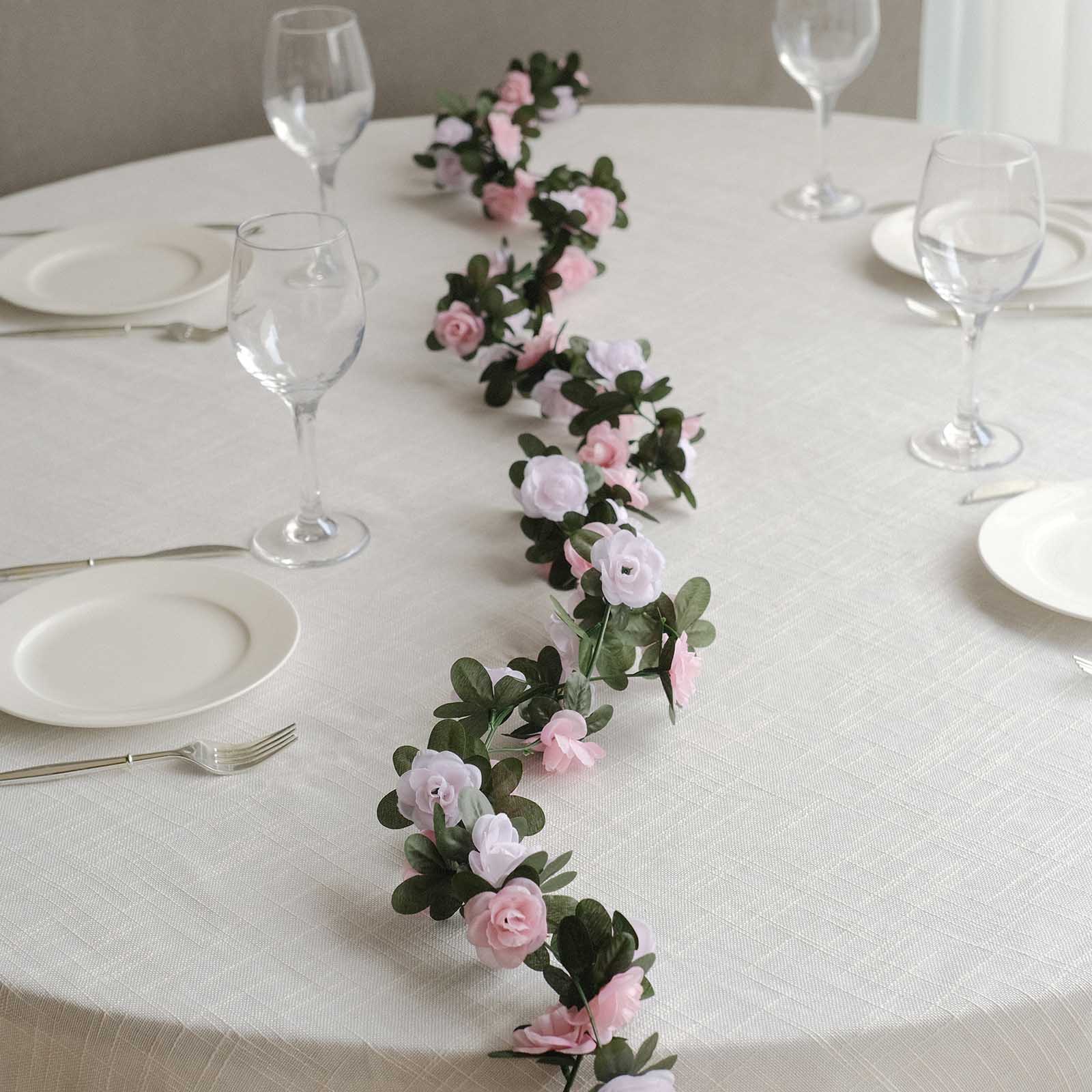 Blush dusty rose artificial silk flower garland on a table setting.
