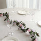 Blush dusty rose artificial silk flower garland on a table setting.