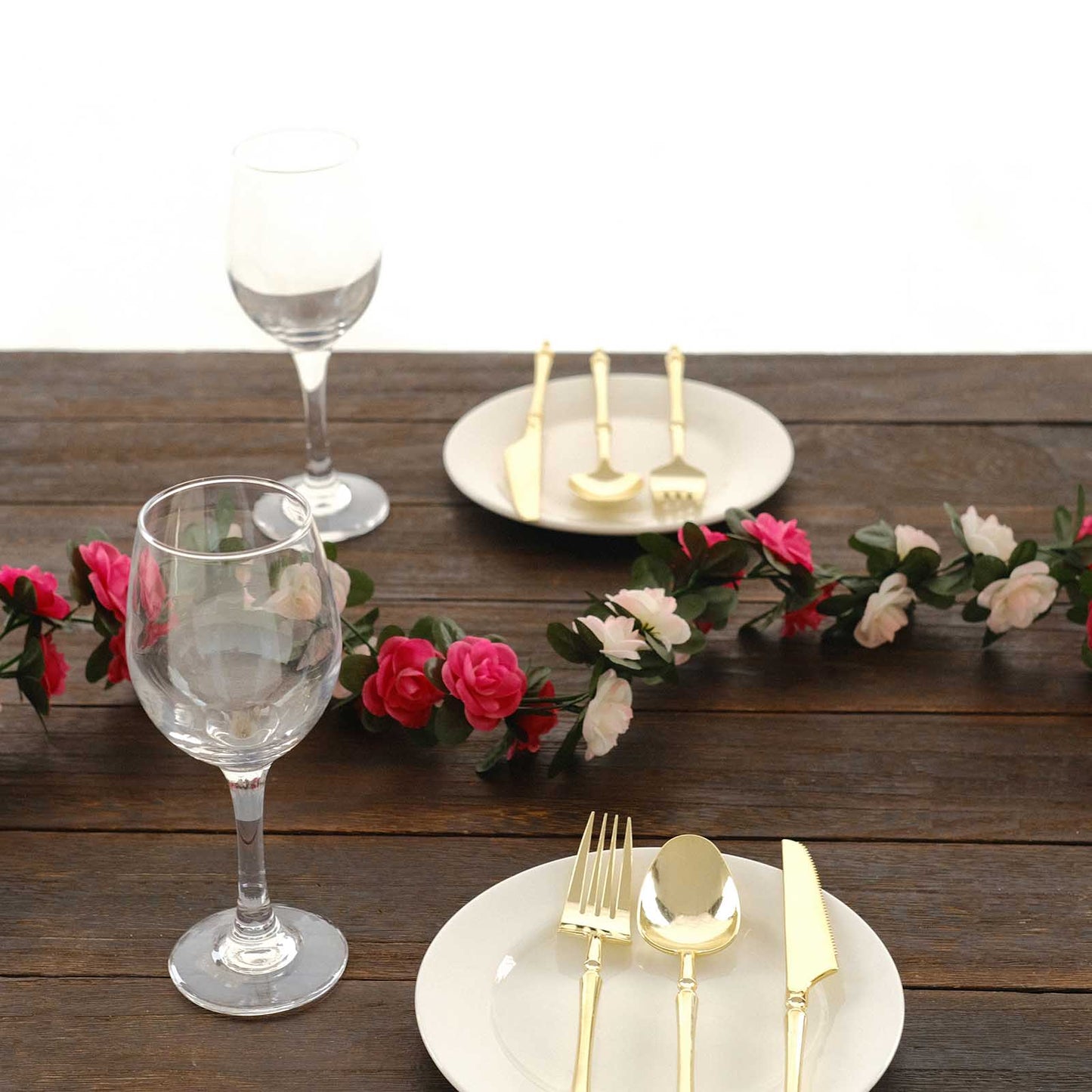 Blush fuchsia artificial silk flower garland with mini rose vines.