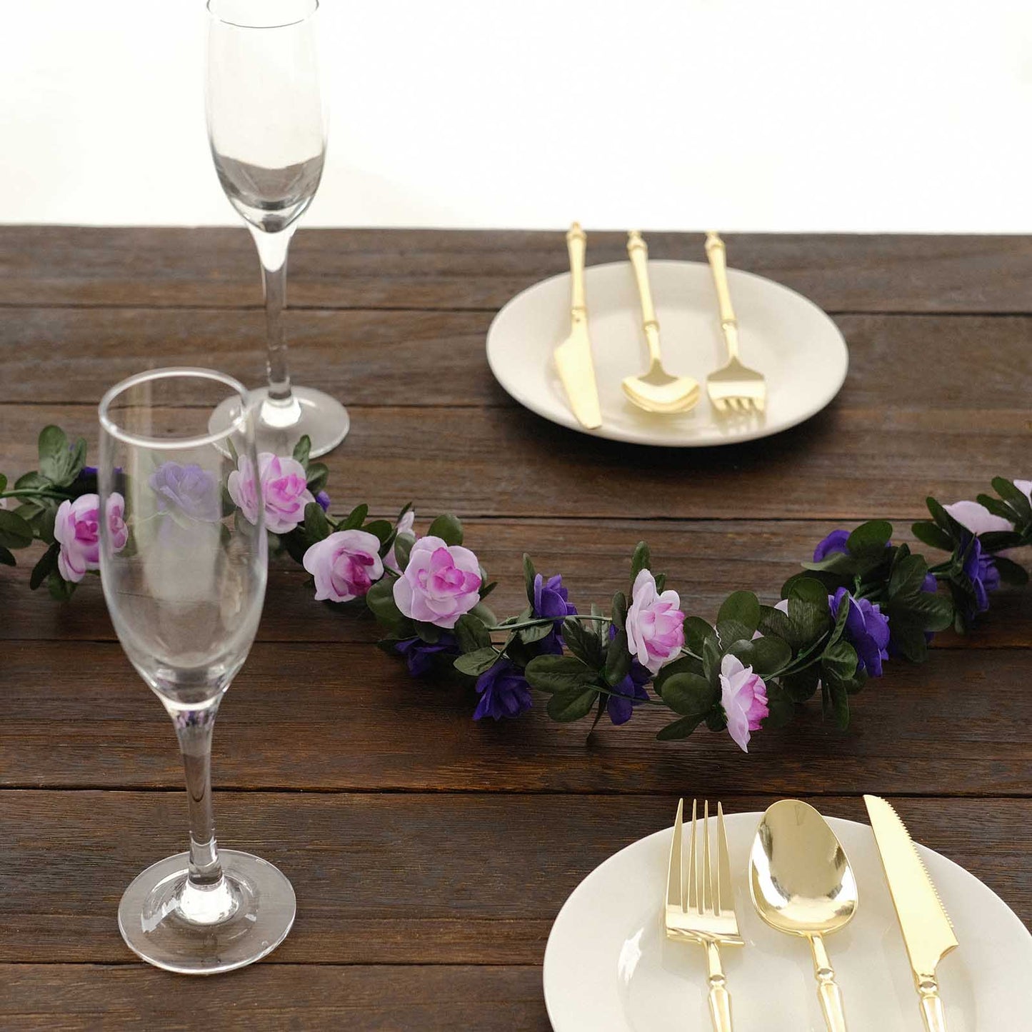Lavender purple artificial silk flower garland with mini roses on a table setting.