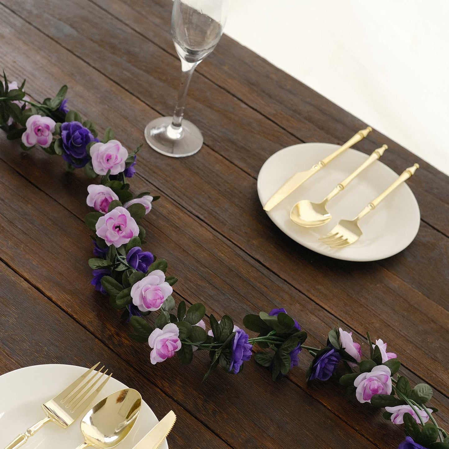 Lavender purple artificial silk flower garland with mini roses and greenery.