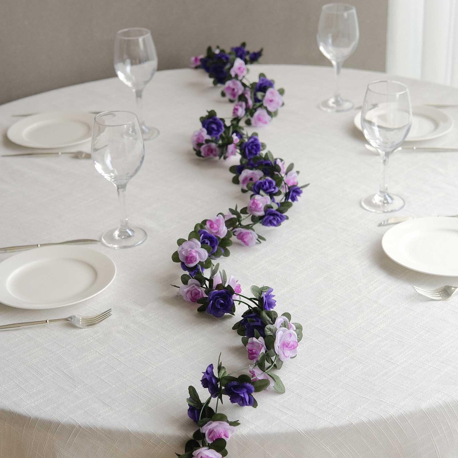 Lavender purple artificial silk flower garland with mini rose vines on a table.