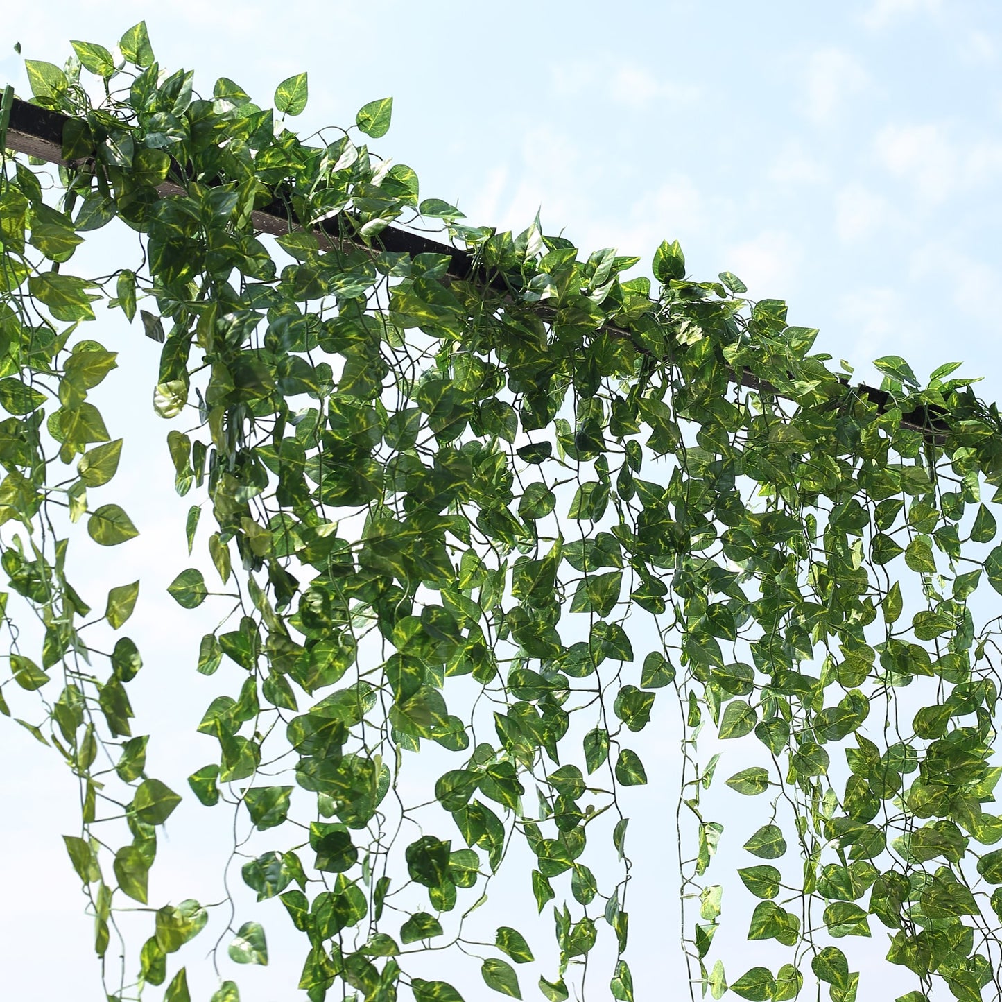 Green artificial ivy vine hanging plants with silk leaves garland.
