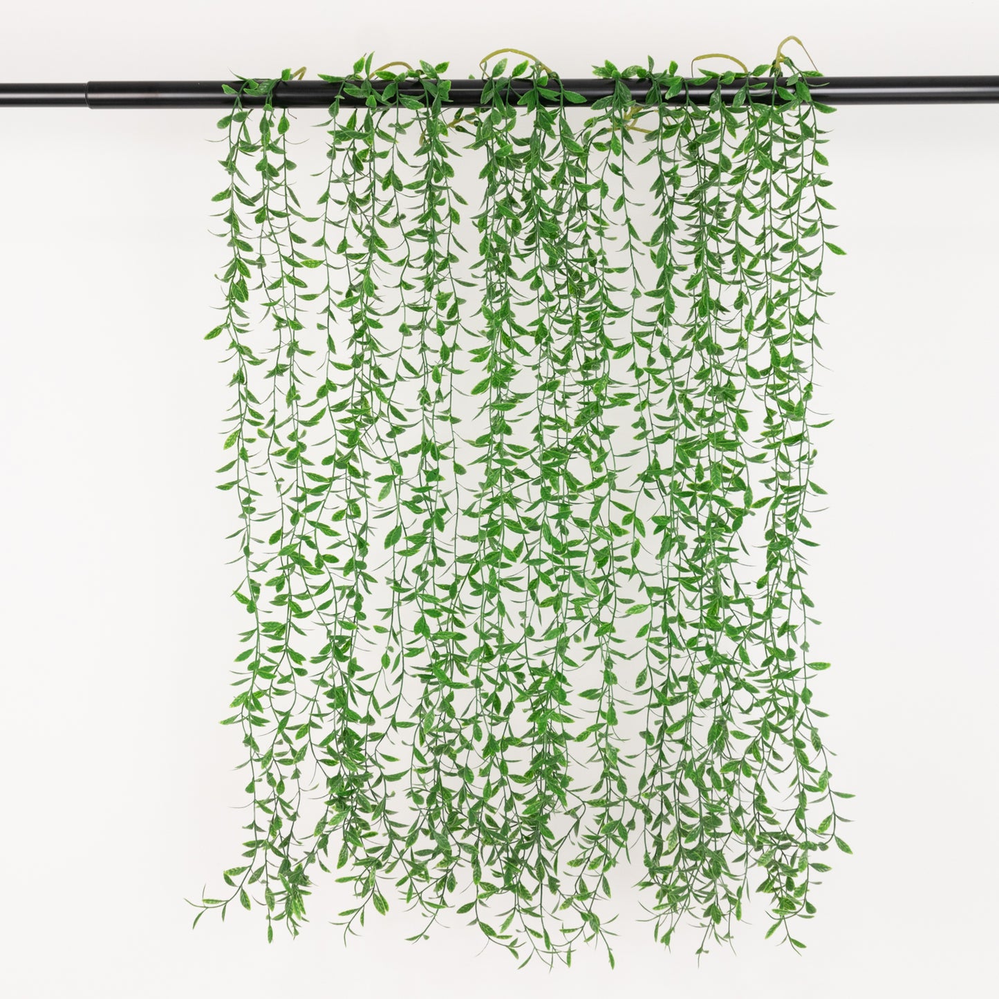 Green artificial hanging fern bushes for vertical garden and vase filler.