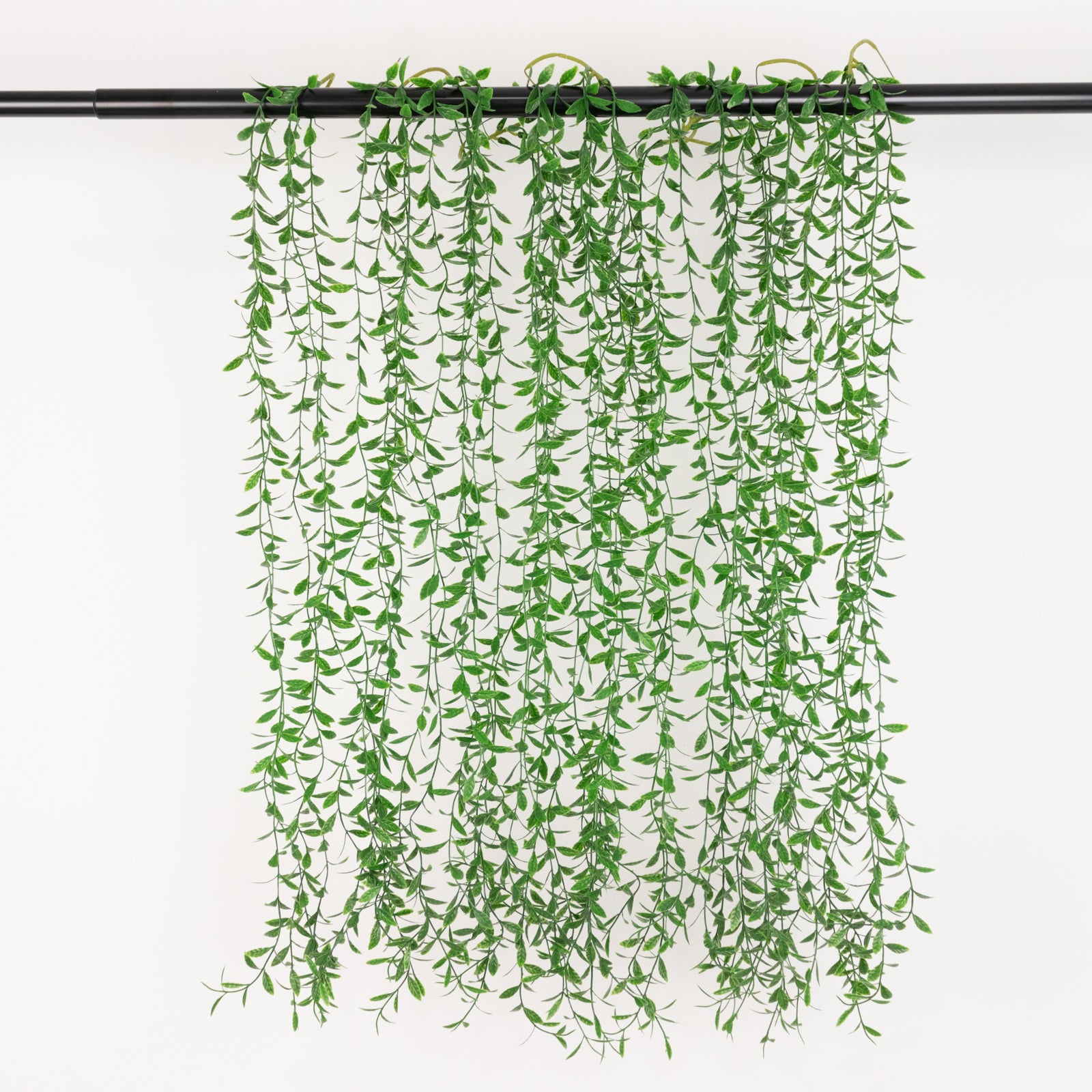 Green artificial hanging fern bushes for vertical garden and vase filler.