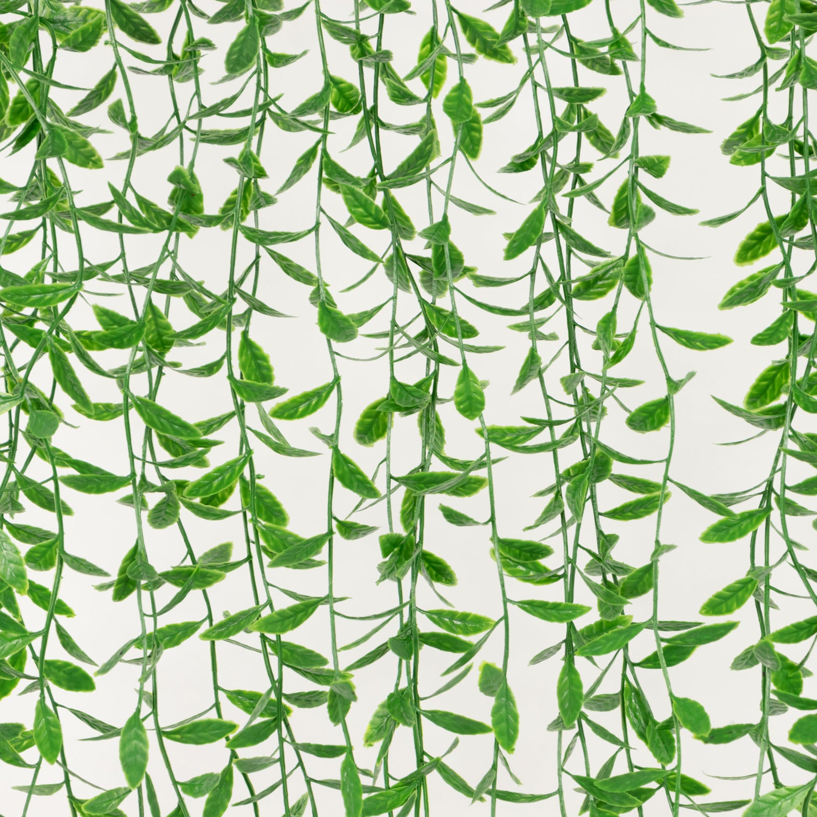 Artificial green hanging vines with weeping willow leaves for wall decor.