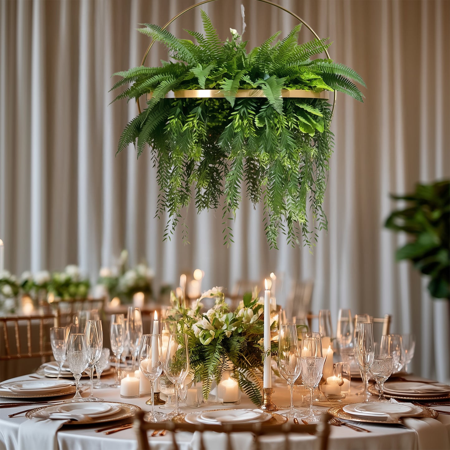 Large faux greenery hoop chandelier in gold with draping ferns.