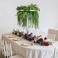 Gold greenery hoop chandelier with draping ferns for boho decor.
