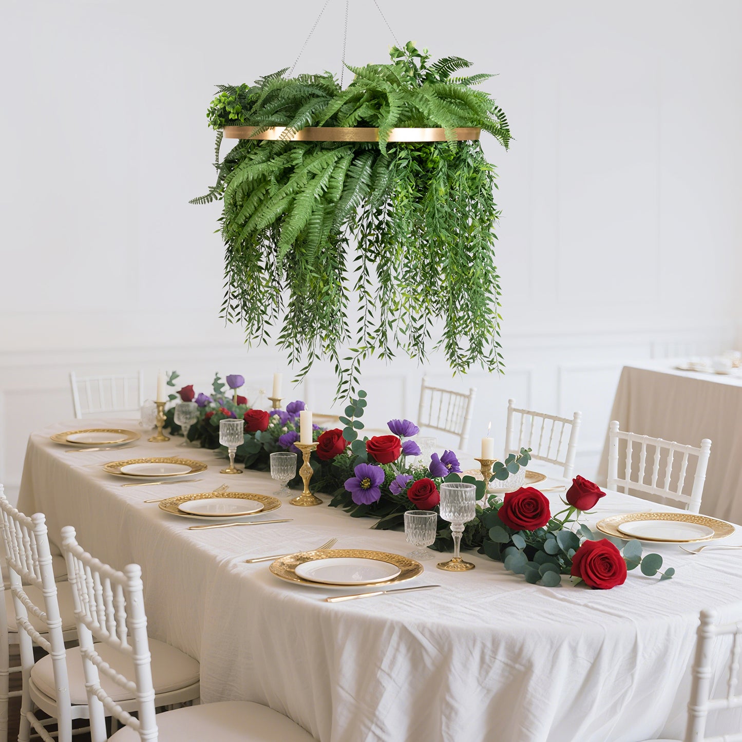 Gold greenery hoop chandelier with draping ferns for boho decor.