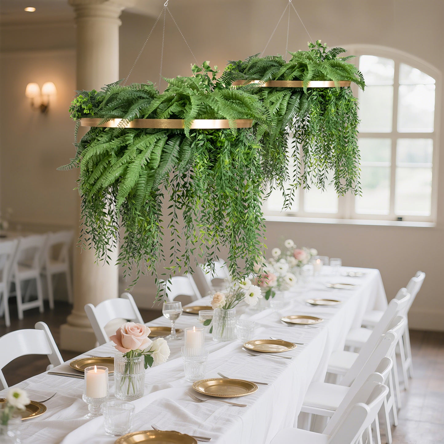 Large faux greenery hoop chandelier in gold with draping ferns.