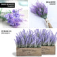 Purple artificial lavender lilac flower bouquet in a wooden planter.