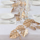 Metallic gold artificial monstera leaf vine table garland.